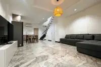 3 Bedroom House for Sale at Wongamat Exclusive Place open-plan living room with marble floors and black staircase