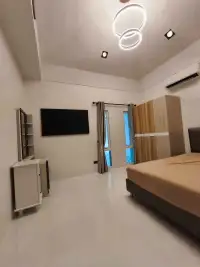 2 Bedroom House for Rent in Pong bright bedroom with wooden wardrobe, bed, and wall-mounted TV