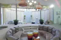 4 Bedroom House for Sale in Huai Yai sunken seating area facing courtyard with stone statues and bamboo wall accents