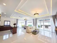 3 Bedroom House for Sale in Huai Yai spacious living area with tray ceiling and glossy marble flooring