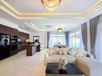 3 Bedroom House for Sale in Huai Yai open-plan living room and kitchen with plush sofa and ceiling lighting