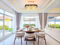 3 Bedroom House for Sale in Huai Yai elegant dining area with crystal chandelier and garden view