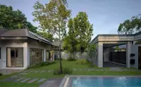 3 Bedroom House for Rent in Huai Yai backyard view with lap pool, covered carport, and landscaped lawn