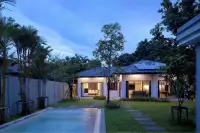 3 Bedroom House for Rent in Huai Yai evening exterior view with illuminated interiors and poolside garden path