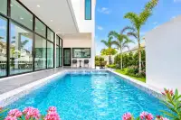 4 Bedroom House for Rent in Huai Yai private swimming pool with poolside seating and tropical garden