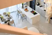4 Bedroom House for Rent in Huai Yai marble kitchen island with dining area and crystal chandelier