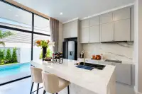 4 Bedroom House for Rent in Huai Yai modern kitchen with marble countertops and pool view window