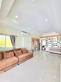 4 Bedroom House for Rent in Huai Yai spacious living room with brown sofa and glossy tiled floors