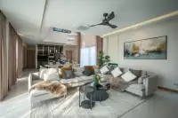 4 Bedroom House for Rent in Huai Yai open-plan living room with sectional sofa and view to dining area