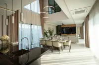 4 Bedroom House for Rent in Huai Yai dining area with elegant table setting and kitchen island