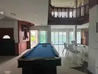 5 Bedroom House for Rent in Huai Yai game room with blue billiard table and view toward living area