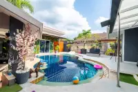 5 Bedroom House for Sale & Rent in Huai Yai poolside patio with lounge chairs, pool float, and garden wall decor