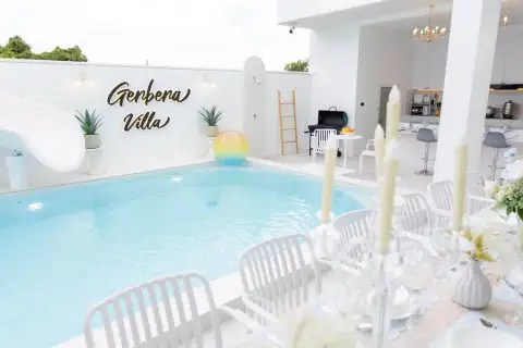 6 Bedroom House for Sale in Huai Yai outdoor pool area with dining setup, BBQ grill and open kitchen
