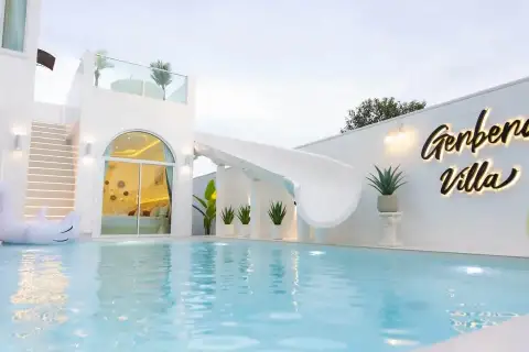 6 Bedroom House for Sale in Huai Yai poolside view at dusk with curved water slide and villa signage