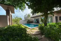 2 Bedroom House for Rent in Huai Yai lush garden with private swimming pool and stone pathway