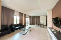 2 Bedroom House for Rent in Huai Yai spacious lounge with dining table and wall-mounted TV