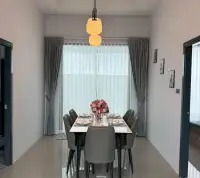 3 Bedroom Townhouse for Rent in Huai Yai dining area with six-seat table and pendant lighting