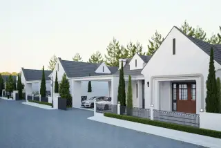 Araya Valley row of modern white townhouses with dark grey roofs and carports, surrounded by tall green trees.