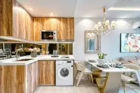 1 Bedroom Condo for Sale at The Riviera Santa Monica kitchen with wood cabinets, dining table, and washing machine.