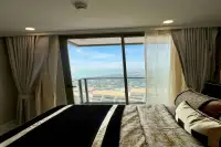 1 Bedroom Condo for Rent at Copacabana Beach Jomtien bedroom with double bed and floor-to-ceiling sea view window
