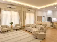 3 Bedroom House for Rent at Garden Ville 9 open-plan living room with curved sofa and kitchen view