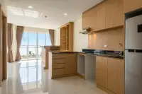 3 Bedroom Condo for Sale at Whale Marina open-plan kitchen with wooden cabinets, black countertops and sea view balcony