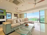 1 Bedroom Condo for Sale at The Park Jomtien spacious lounge with sectional sofa and balcony city view