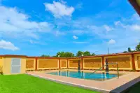 4 Bedroom House for Sale & Rent at Miami Villas outdoor pool area with decorative statues and patterned boundary wall