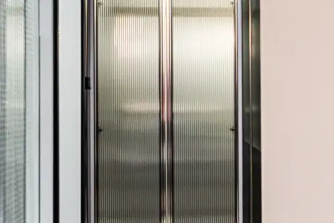 2 Bedroom Condo for Sale at Embassy Life close-up of ribbed frosted glass wardrobe doors with black metal frame