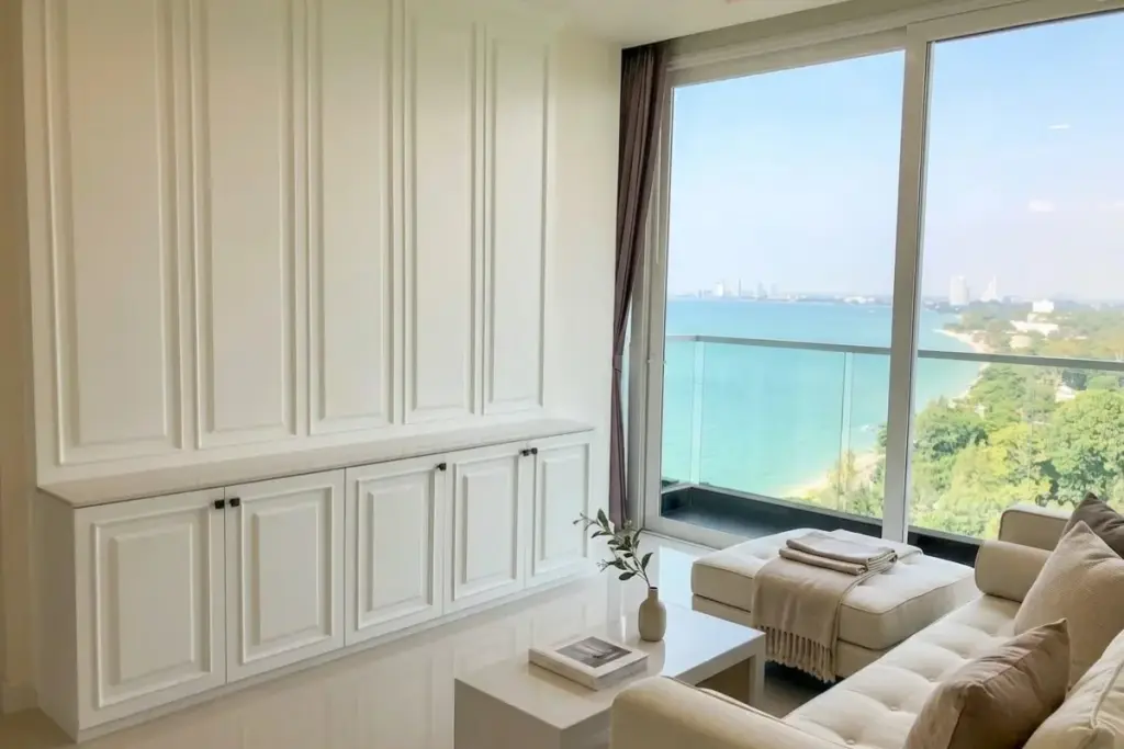 2 Bedroom Condo for Sale at Del Mare bright living room with white panelled wall and panoramic sea view balcony