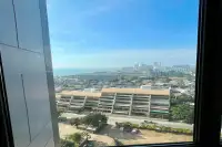 1 Bedroom Condo for Rent at Copacabana Beach Jomtien high-floor window view of Jomtien cityscape and ocean