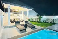 4 Bedroom House for Sale at Rattanakorn Village 18: Poolside view with lounge chairs, covered patio, and outdoor furniture.