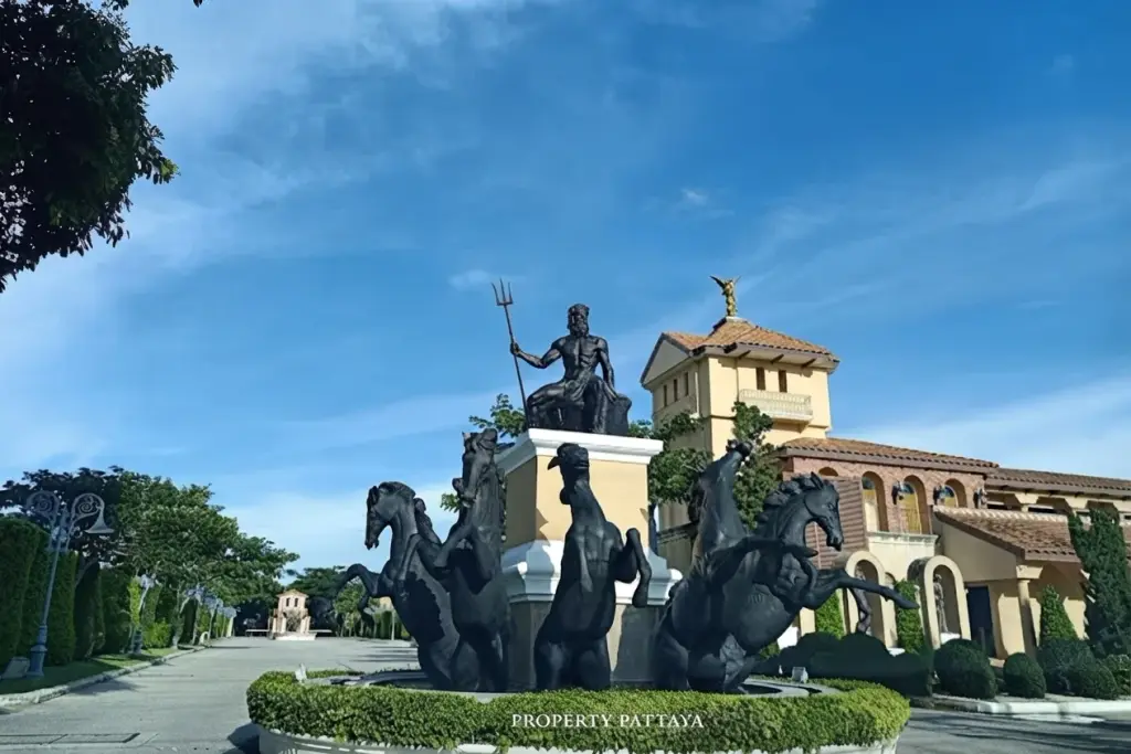 Nusa Chivani Pattaya grand entrance with a large Neptune statue fountain and horse sculptures, leading to a classical building.