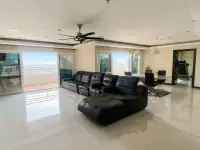 2 Bedroom Condo for Sale at PKCP Tower open living area with leather sofa, balcony, and dining space