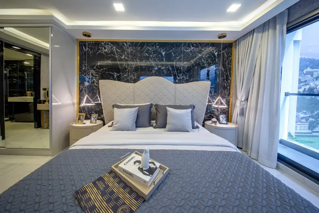 3 Bedroom Condo for Sale at Grand Solaire Noble master bedroom with black marble feature wall and city view at night