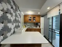 2 Bedroom Condo for Sale at Jomtien Beach Paradise kitchen with wooden cabinetry and balcony access