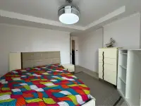 2 Bedroom Condo for Sale at Jomtien Beach Paradise bedroom with colorful bedspread and cream dresser
