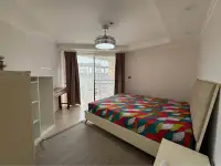 2 Bedroom Condo for Sale at Jomtien Beach Paradise bedroom with balcony door and sheer curtains