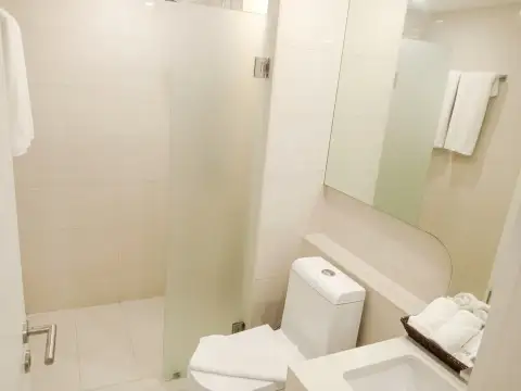 1 Bedroom Condo for Sale at City Center Residence bathroom with frosted glass shower enclosure and toilet
