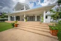 4 Bedroom House for Sale in Nong Prue featuring a covered patio with columns and wide steps leading to the lawn.