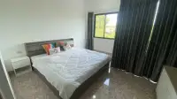 2 Bedroom Townhouse for Sale in Jomtien master bedroom with king bed and dark curtains