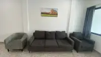 2 Bedroom Townhouse for Sale in Jomtien seating area with gray sofas and framed wall art