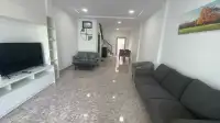 2 Bedroom Townhouse for Sale in Jomtien open-plan living room with gray sofas and marble flooring