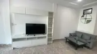2 Bedroom Townhouse for Sale in Jomtien living area with white TV unit and built-in shelving