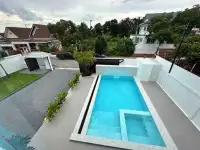 5 Bedroom House for Sale & Rent in Jomtien aerial view of rectangular swimming pool with tiled deck
