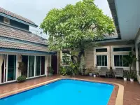 5 Bedroom House for Sale in Jomtien poolside courtyard shaded by a large frangipani tree