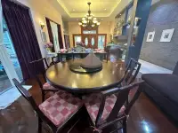 5 Bedroom House for Sale in Jomtien dining area with round wooden table and chandelier