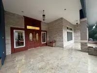 5 Bedroom House for Sale in Jomtien covered entrance with ornate wooden double doors and marble flooring
