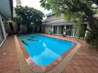 5 Bedroom House for Sale in Jomtien outdoor swimming pool with tiled patio and tropical garden