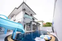 6 Bedroom House for Sale & Rent in Jomtien pool area with blue water slide and inflatable floats